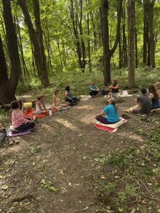 people gathering in circle in the heritage forest.