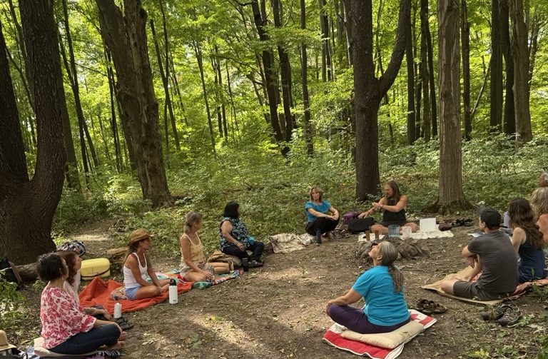 people gathering in circle in the heritage forest.